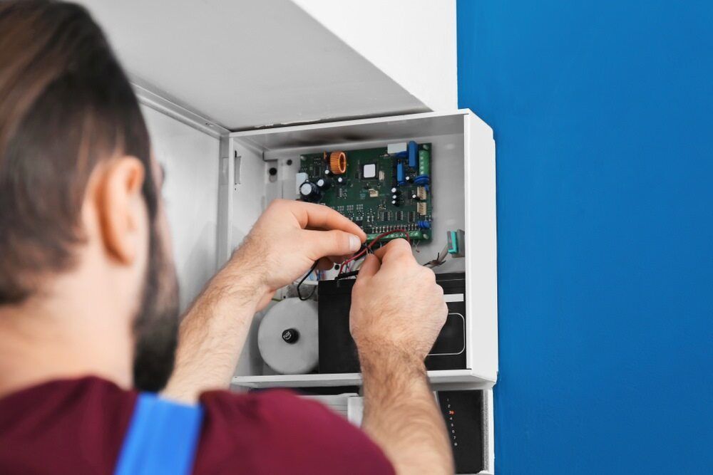 Expert Electrician Checking Switch Board Wires — Premium Electrical Solutions in Bundaberg, QLD