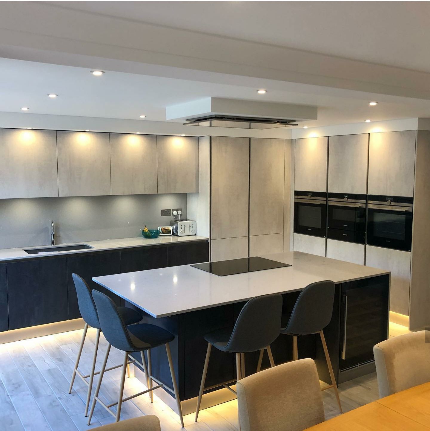 A kitchen with a large island and a table and chairs