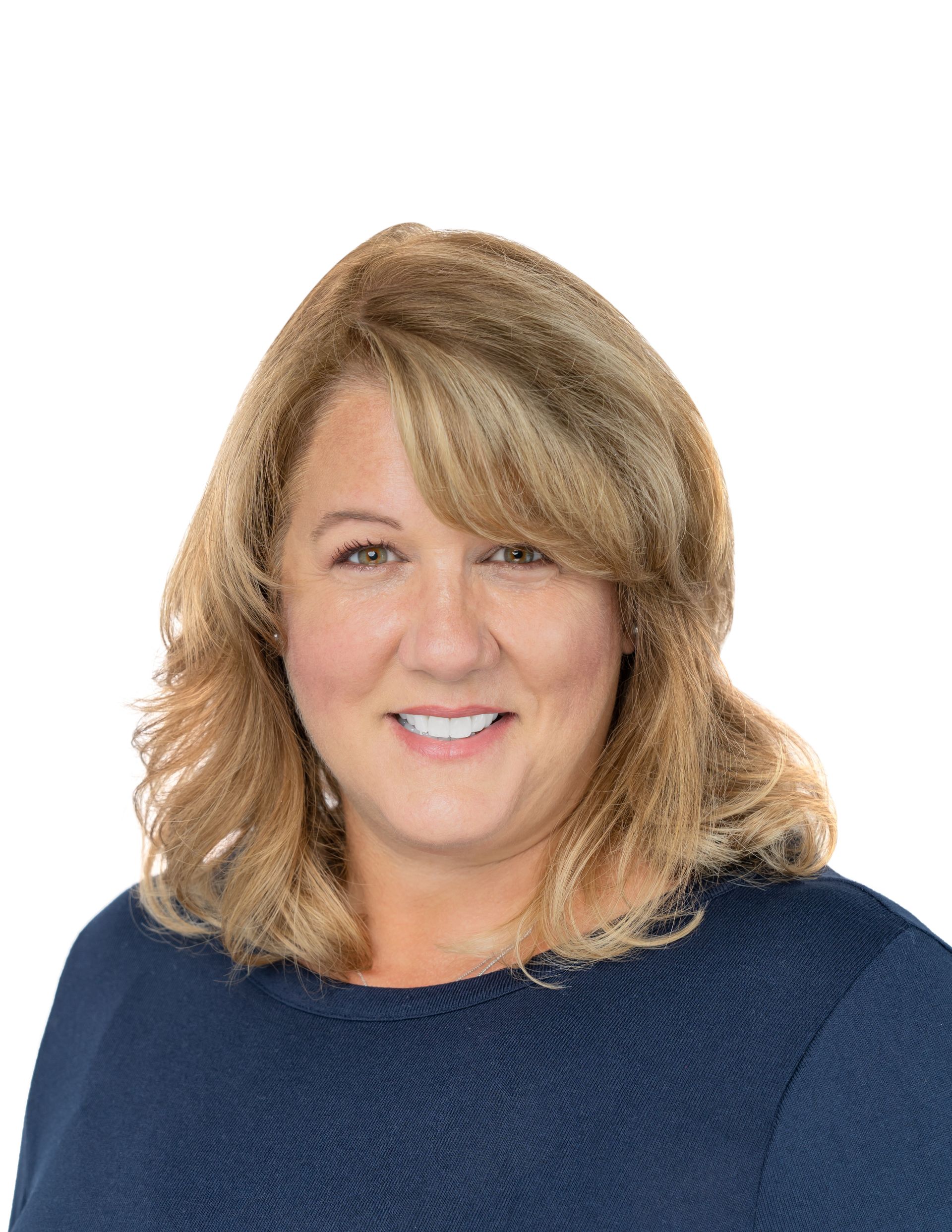 Portrait of a smiling woman in a navy sweater against a white background