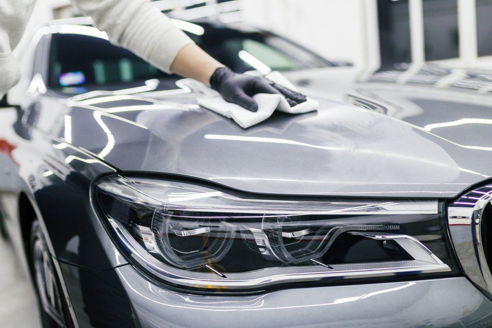 washing a car's front end with a towel
