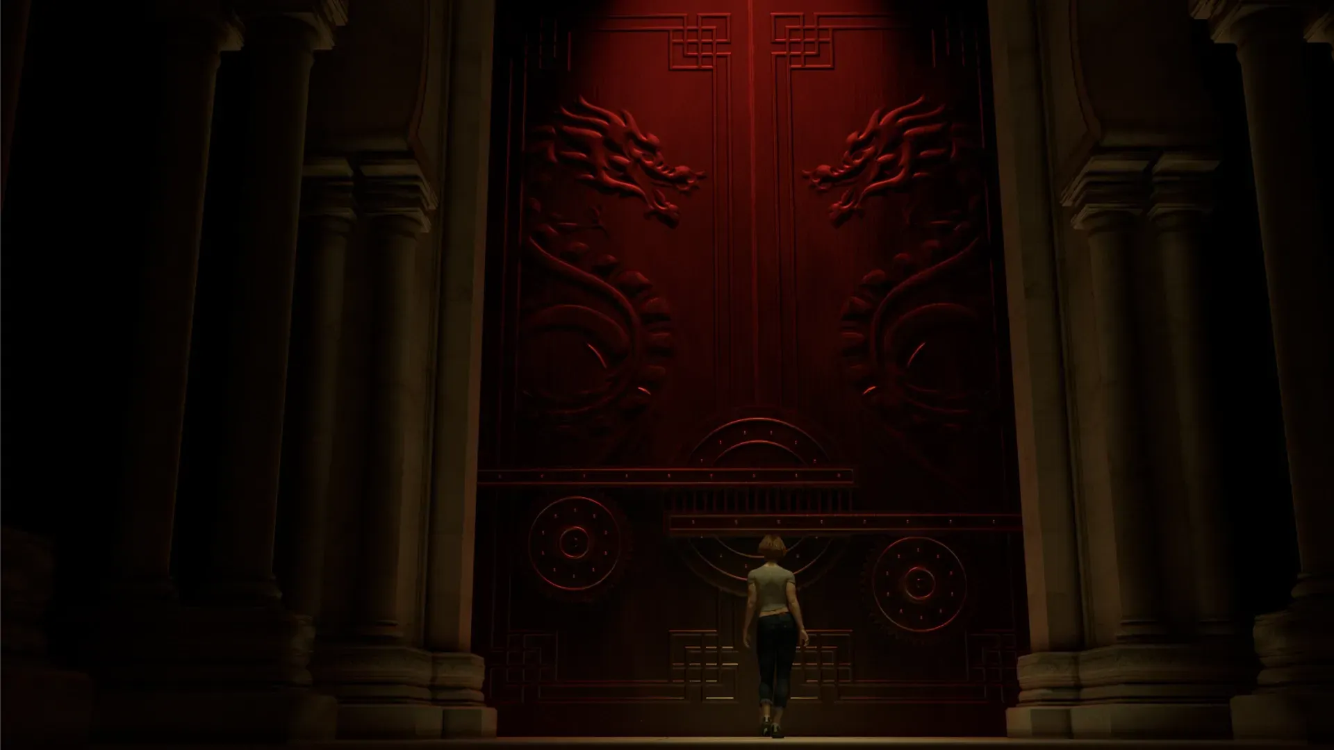 A woman is standing in front of huge ornamental doors that have dragons carved on them. 