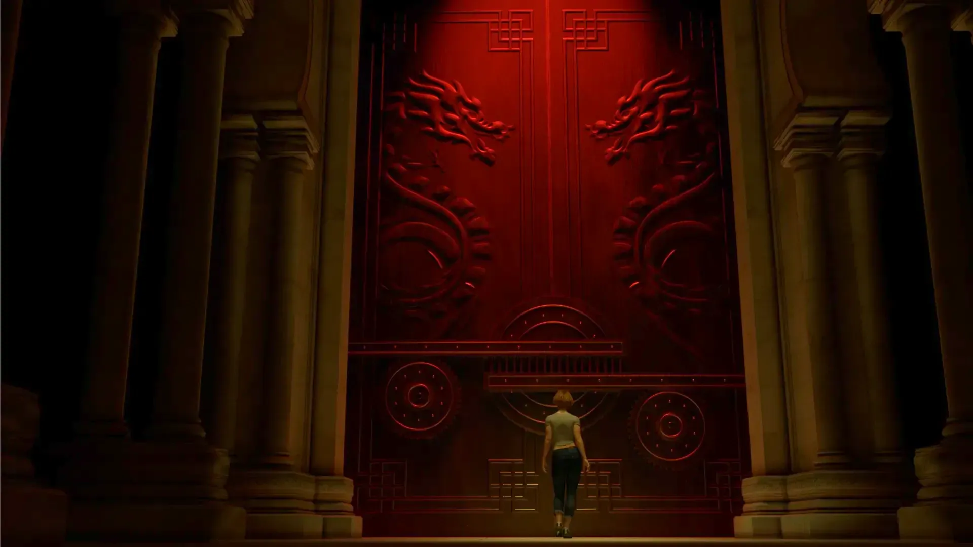 A woman is standing in front of a large red door.