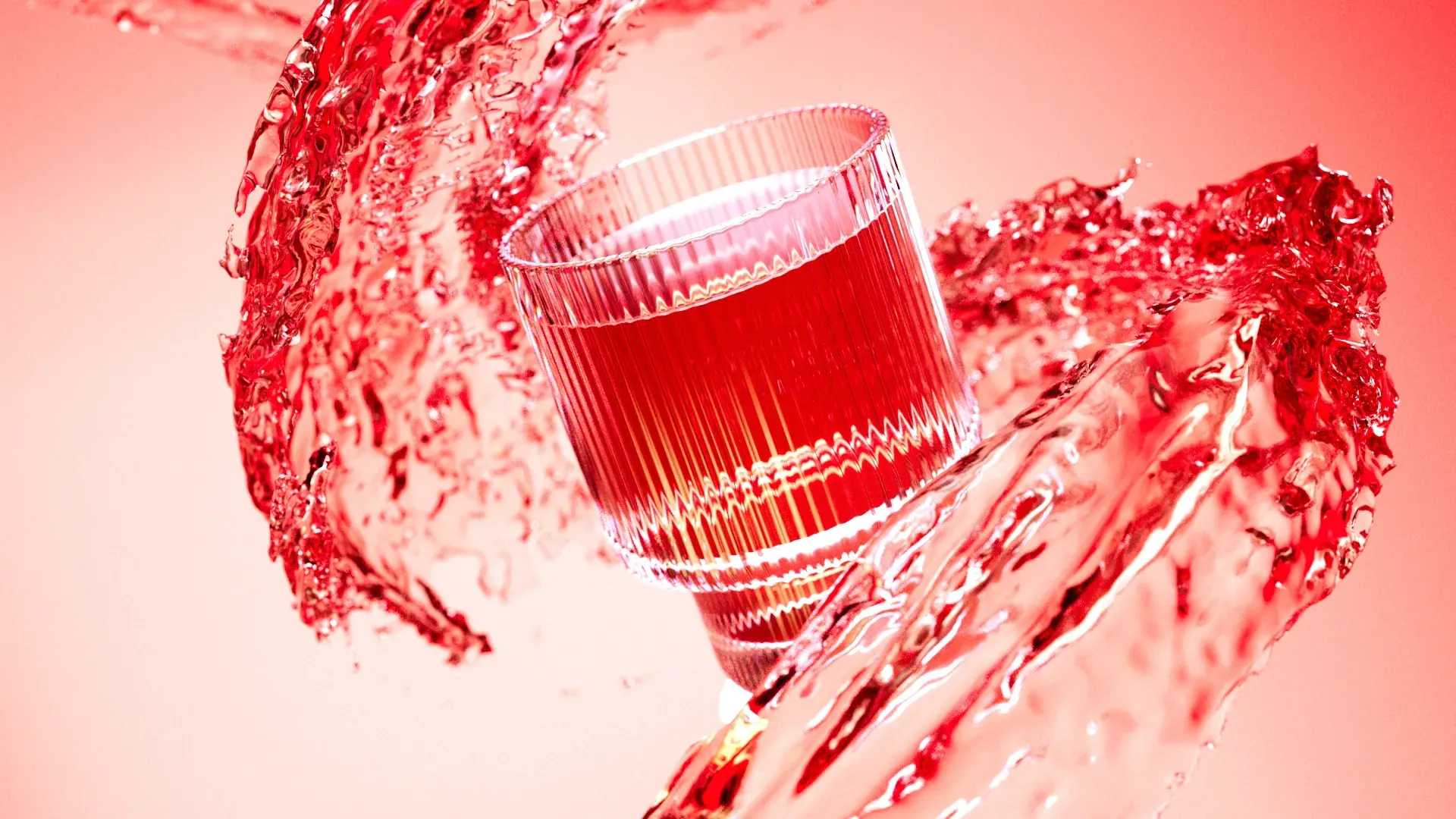 Red-tinted close-up of a full decorative glass splashing through water, creating dynamic droplets