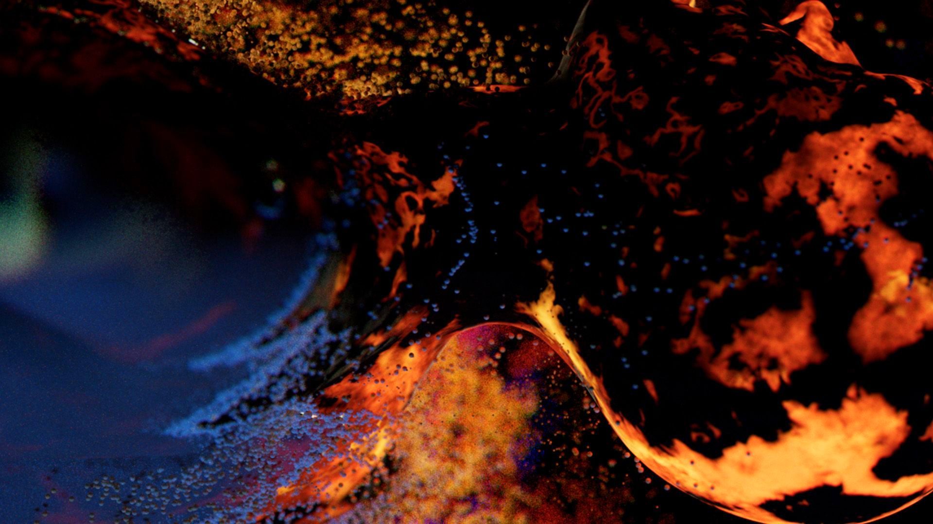 A close up of a fire with a dark background