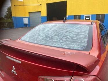 Red Car With Shattered Rear Windshield, Parked Outside — Mobile Windscreens FNQ in Cardwell, QLD