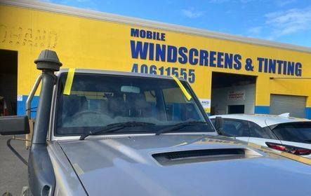 Silver Vehicle With Yellow Tape on Windshield — Mobile Windscreens FNQ in Cardwell, QLD