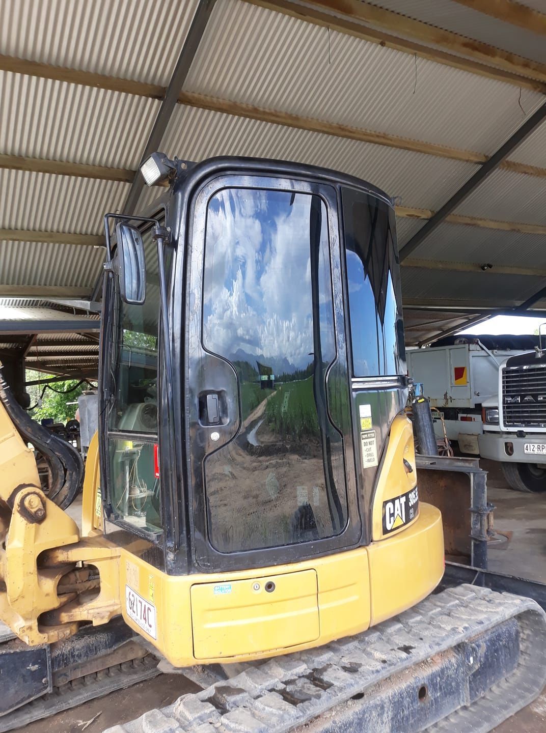 Yellow Caterpillar Excavator Cab — Mobile Windscreens FNQ in Tully, QLD