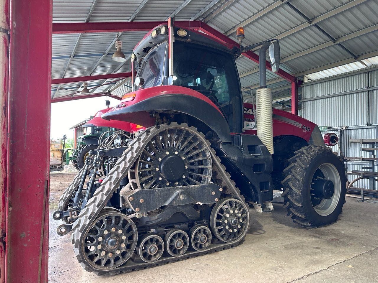 Red and Black Case Tractor With Tracks Parked in a Shed — Mobile Windscreens FNQ in Atherton, QLD