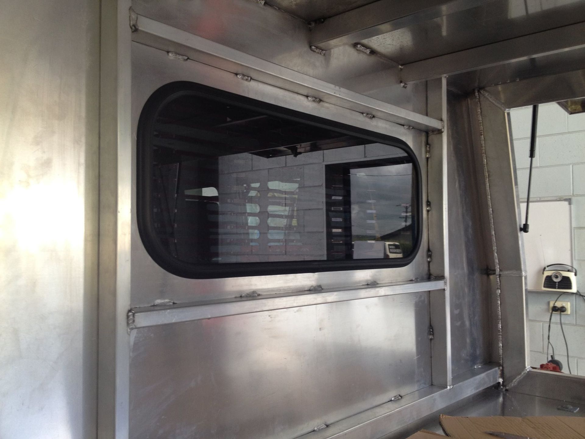 Aluminum Vehicle Frame With an Installed Black-framed Window — Mobile Windscreens FNQ in Cardwell, QLD