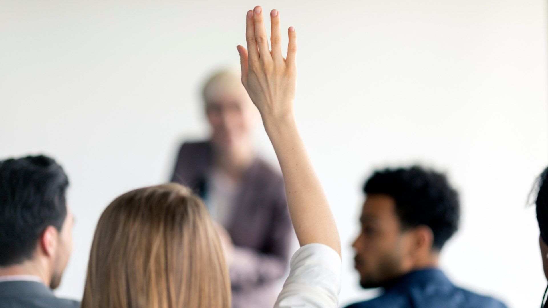 Meeting attendee raising a hand to ask a question