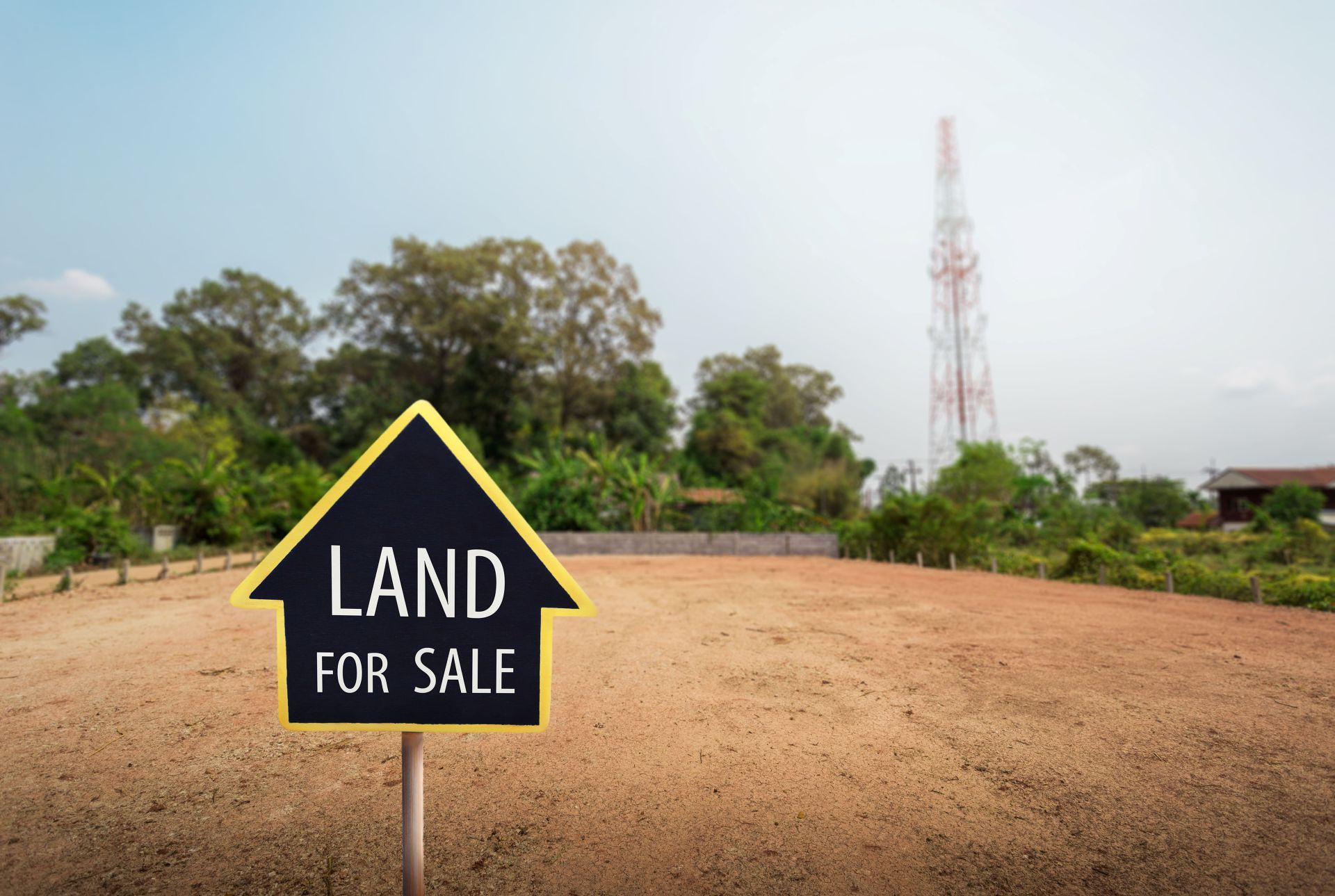 A black, house-shaped sign reading 