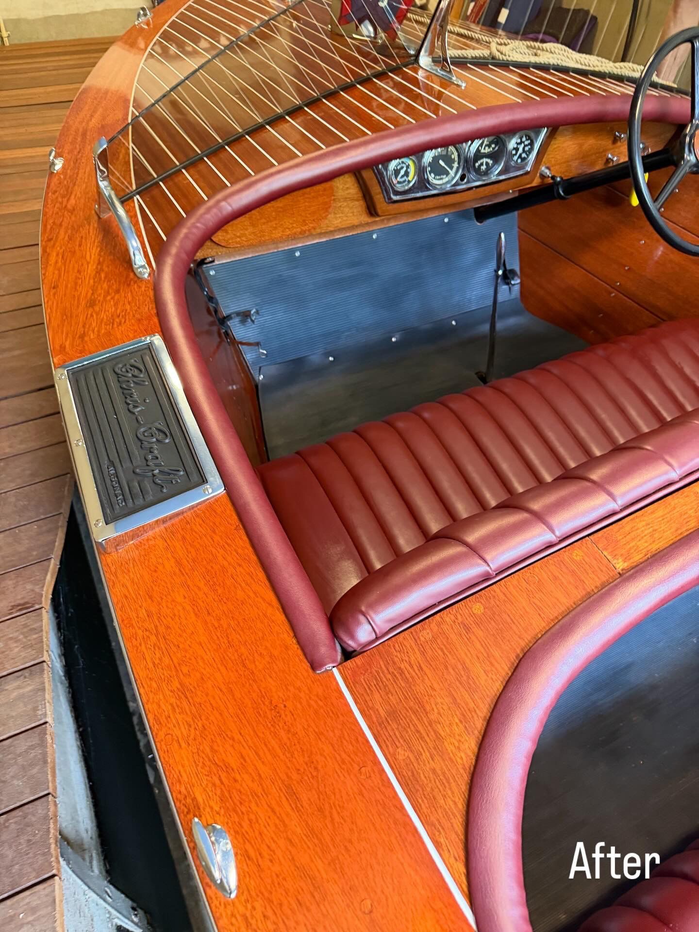 Vintage car interior with red leather seat and polished wood dashboard, viewed from above