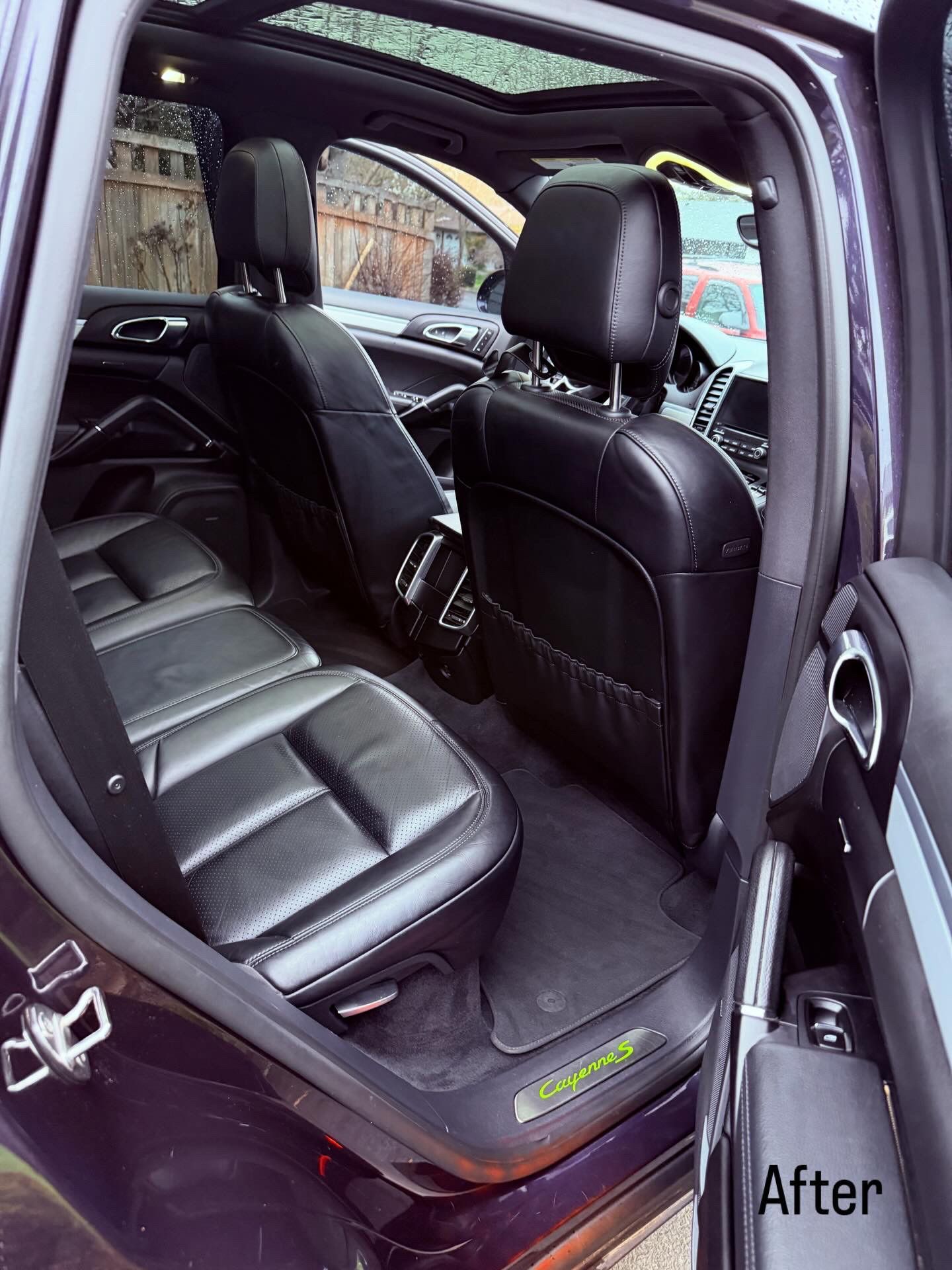 Black car interior with rear seat removed, showing a clean back seat area and front seat backs