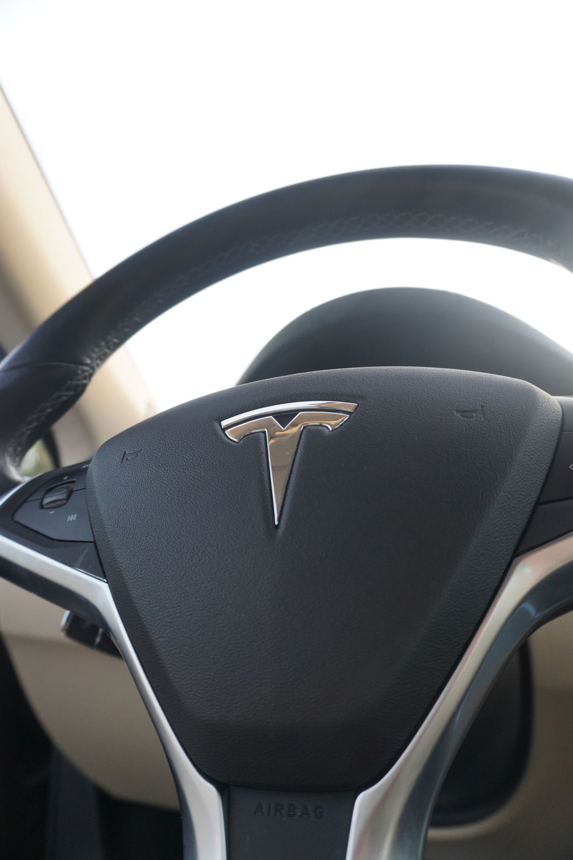 Tesla steering wheel with logo in a car interior
