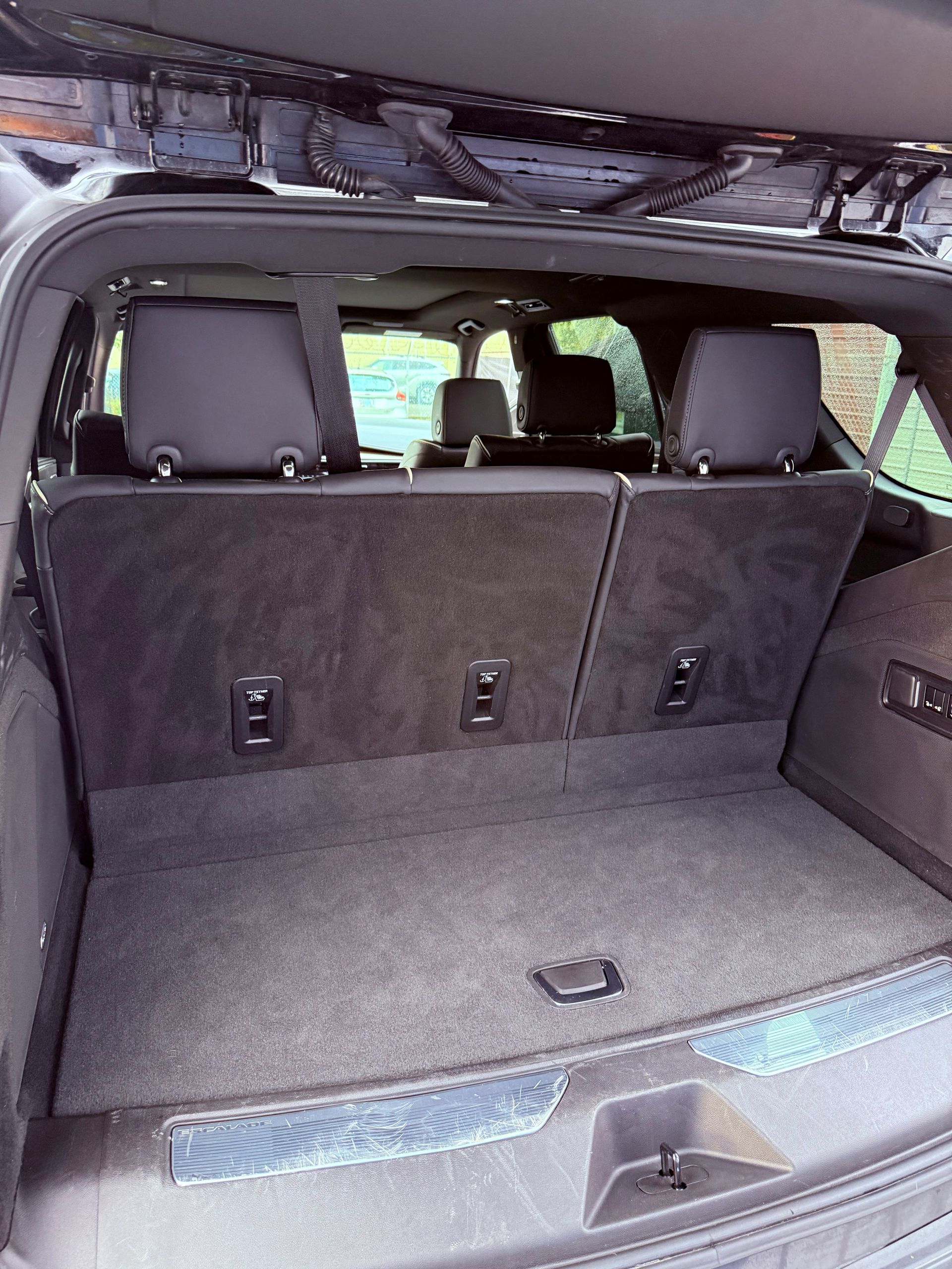 Open SUV cargo area with folded rear seats and gray upholstery