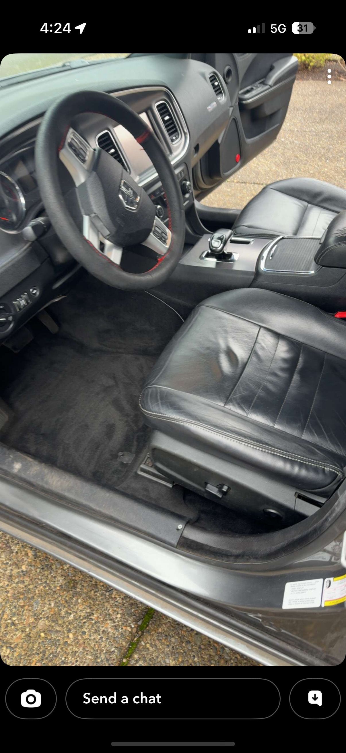 Car interior with black leather seats, steering wheel, and center console.