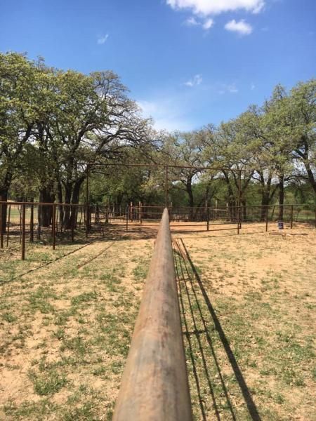 Ranch fencing installed beside open field.