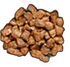 Heap of brown, cubed, cooked chicken pieces against a black background.