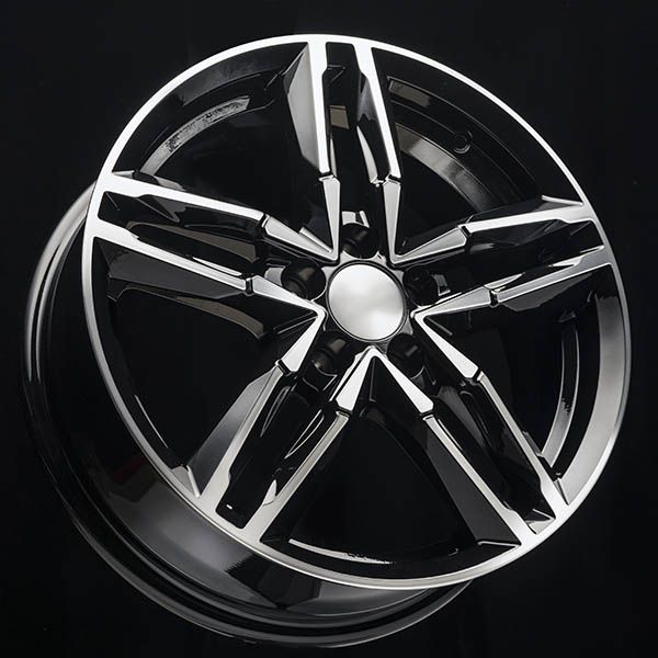 Glossy black alloy car wheel rim with silver spokes on a white background