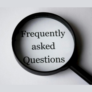 Magnifying glass over the words “Frequently asked Questions” on a gray background