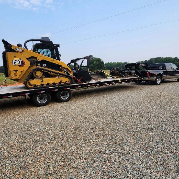 Tractor Being Towed by a Truck