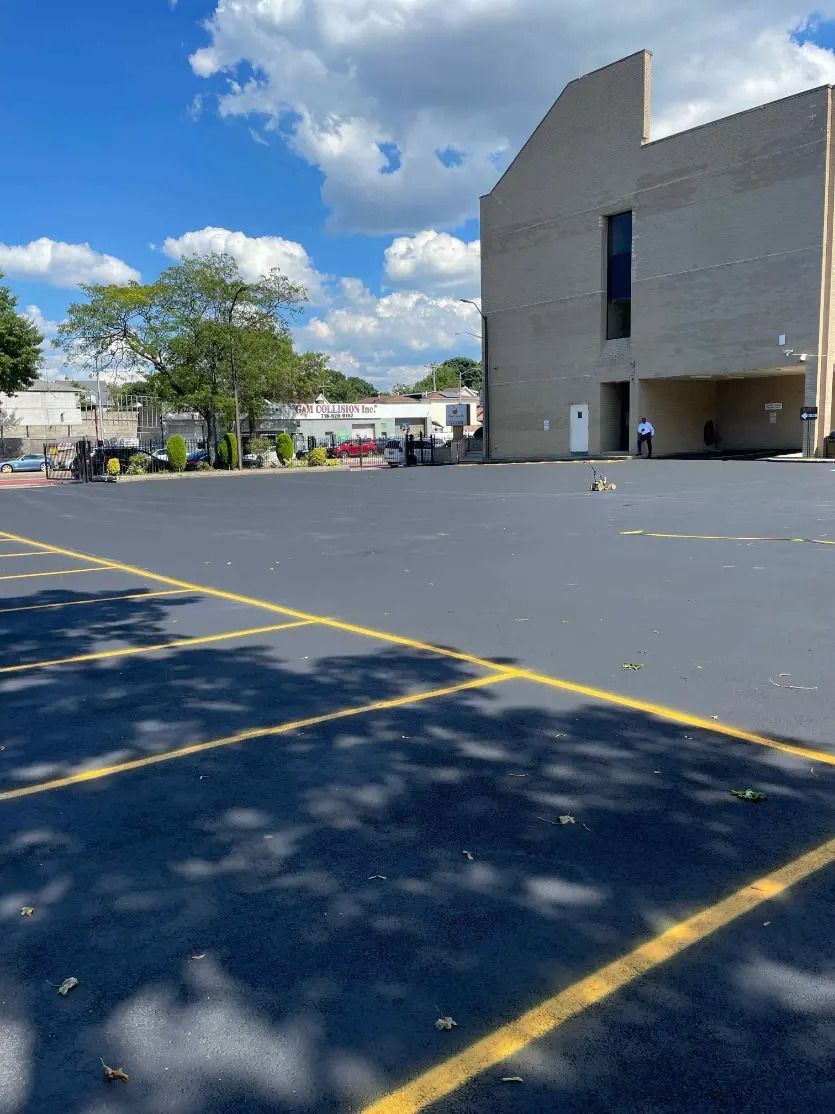 A parking lot with a large building in the background.