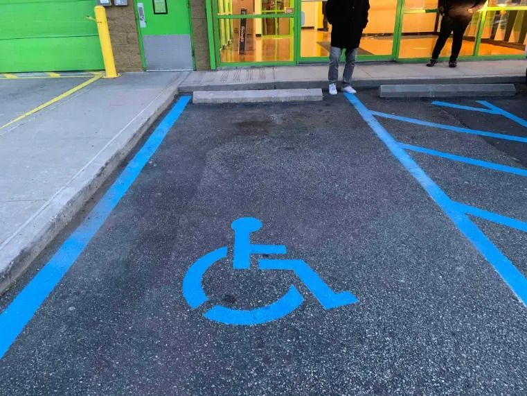 A handicapped parking spot in a parking lot