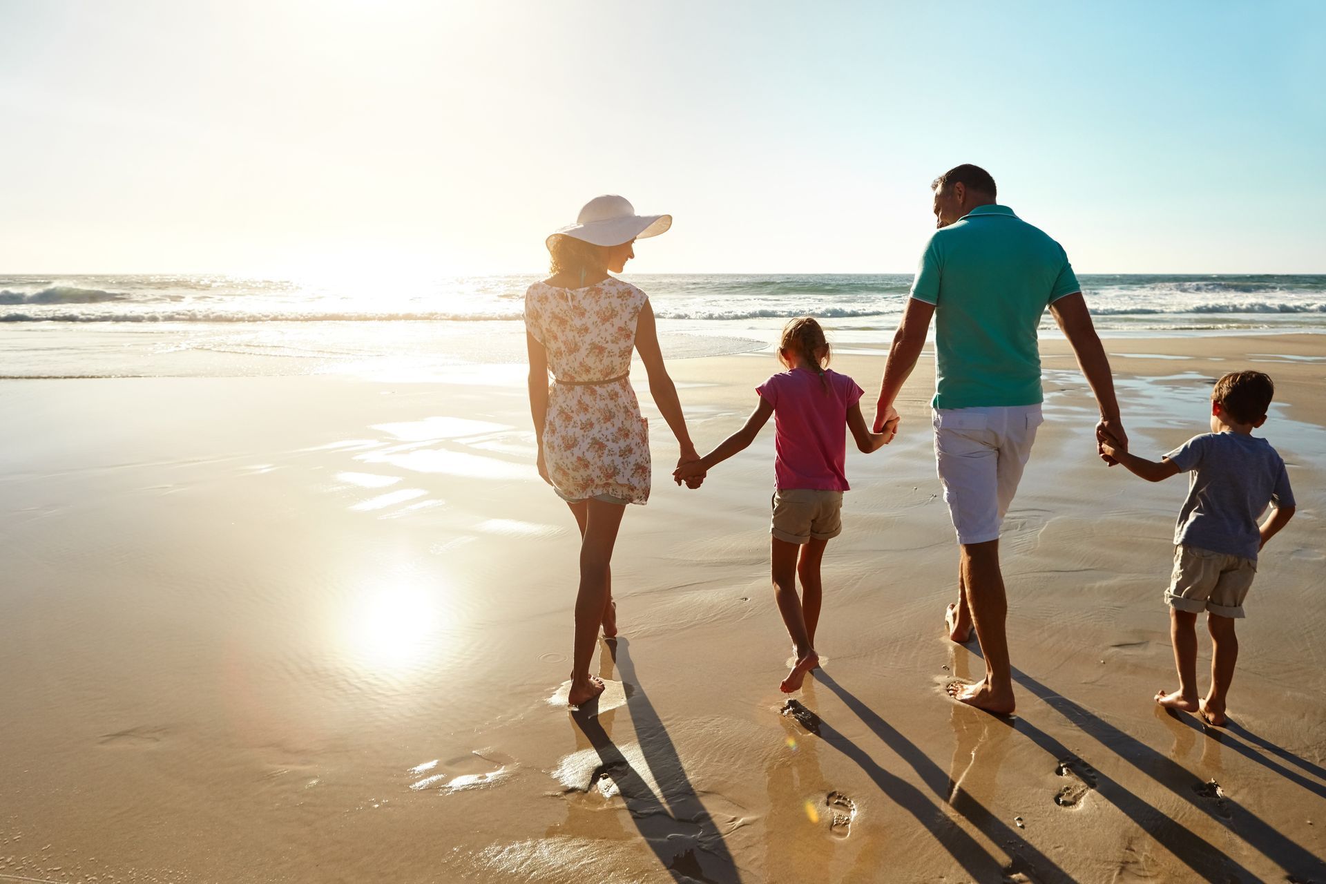 Happy family walking on a beach