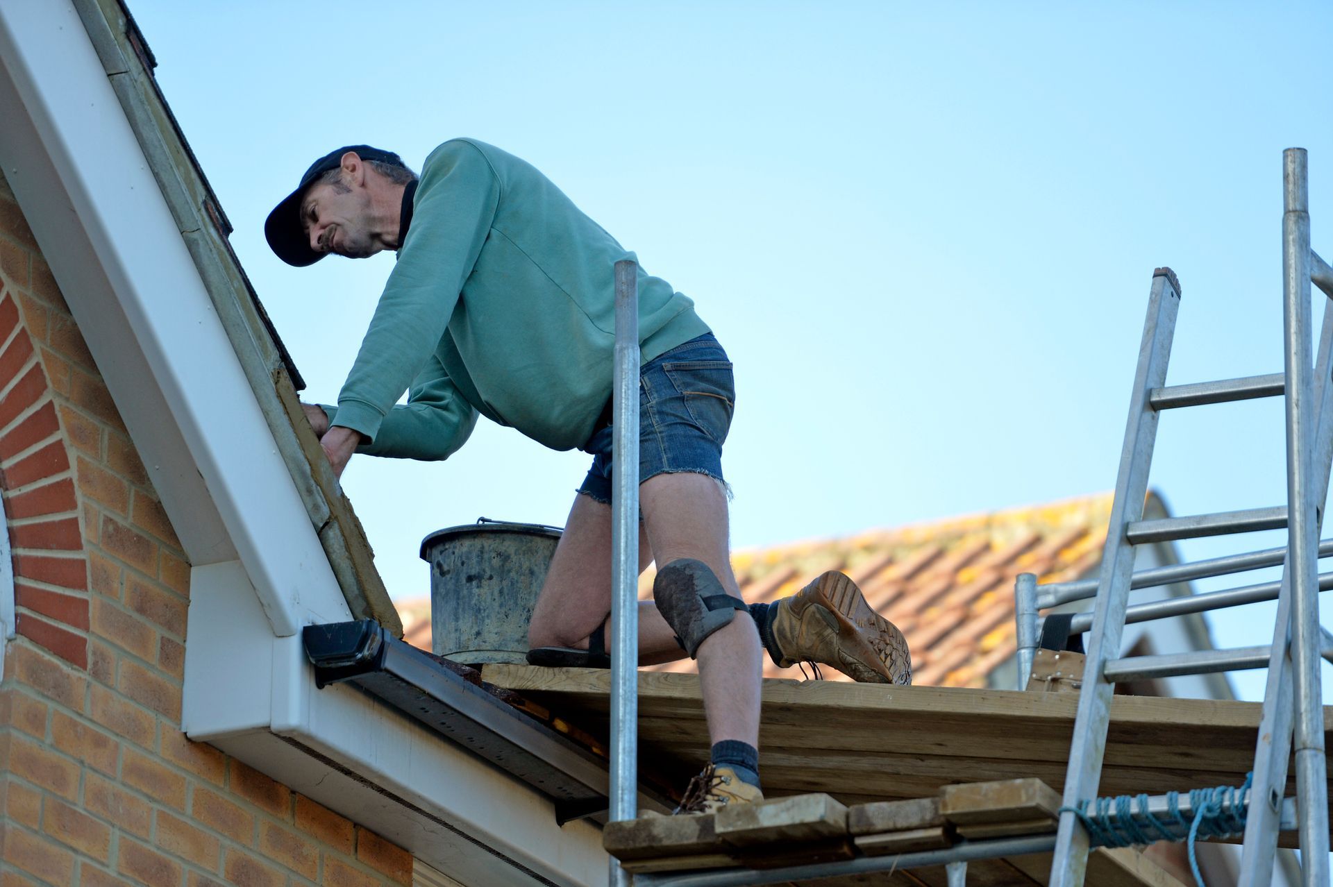 A man is repairing a roof.