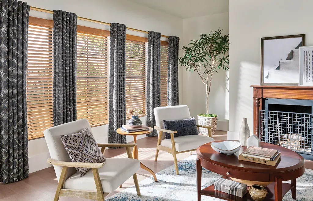 A living room with blue blinds on the windows