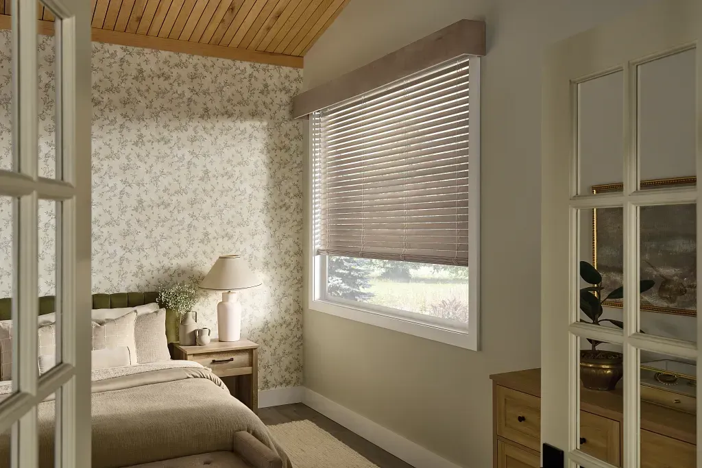 A living room with a chair , table , and window blinds.