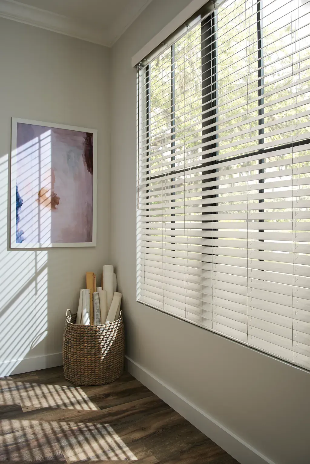 A window with white blinds on it and a view of the mountains.