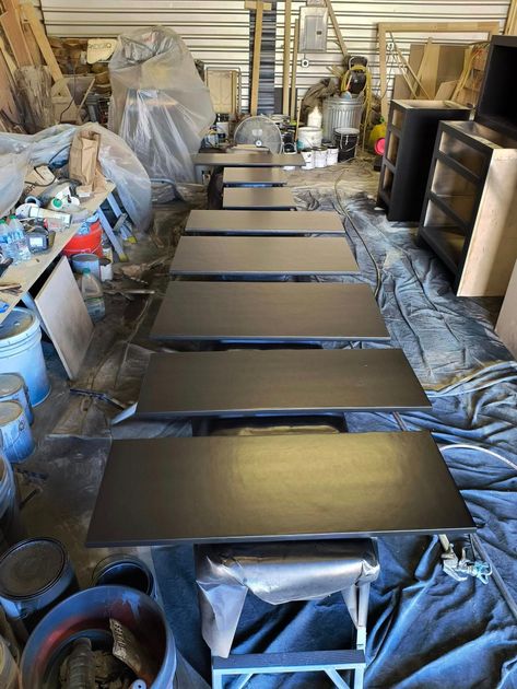 A bunch of tables are sitting on top of each other in a room.