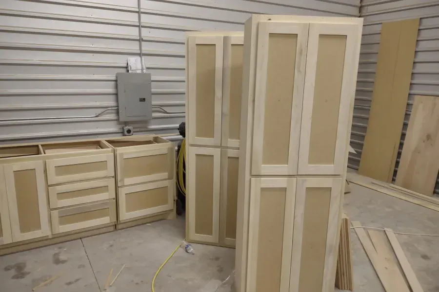 A room filled with lots of wooden cabinets and doors.