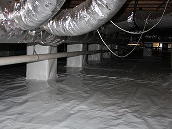Sealed crawlspace with plastic floor covering, exposed ductwork, and pipes overhead