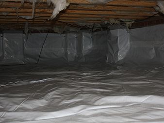 Plastic-covered crawlspace with exposed wooden beams and insulation under the floor