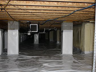 Flooded crawl space with standing water, exposed beams, and covered support columns