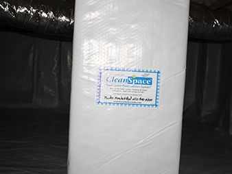 White cylindrical roll wrapped in plastic with a CleanSpace label in a dark industrial setting