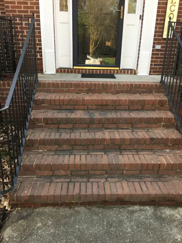 A set of brick stairs leading up to a door