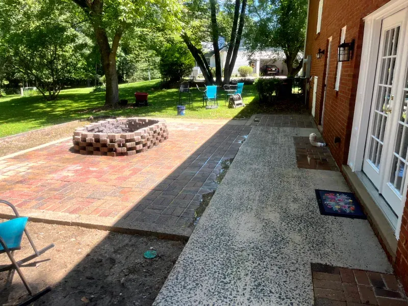 A patio with a fire pit in the middle of it