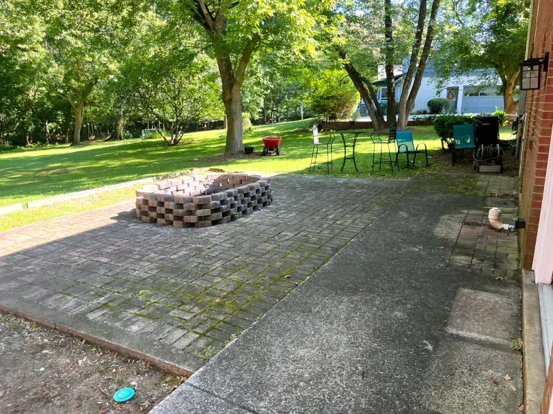 There is a fire pit in the middle of the patio.