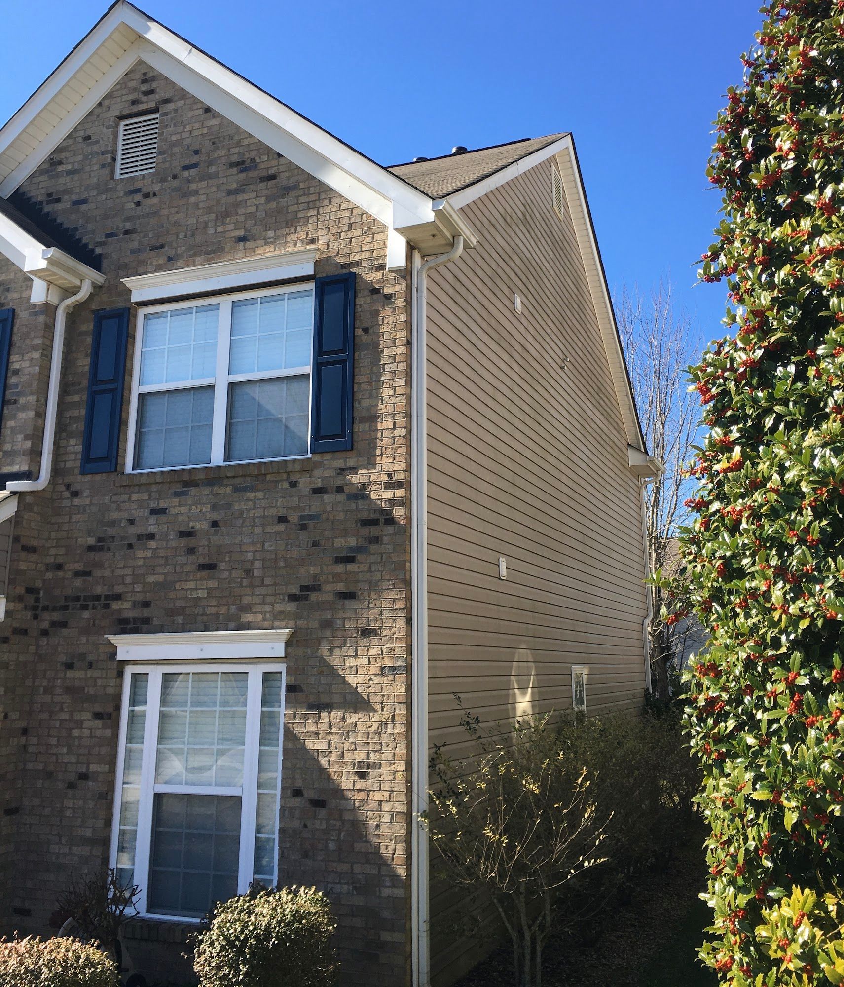 A house with a lot of windows and a blue sky in the background