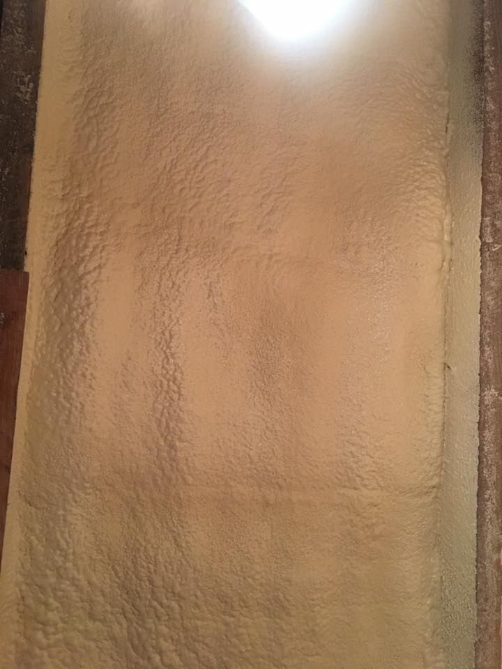 Textured beige wall with a bright light glare at the top center