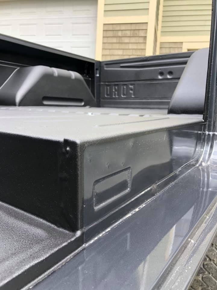Inside of a vehicle with a spay-on bedliner for flooring