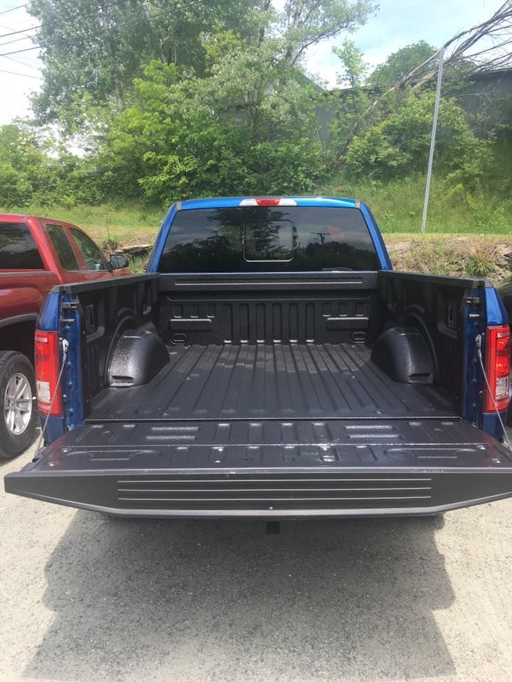 Spray-on bedliner in a blue truck bed