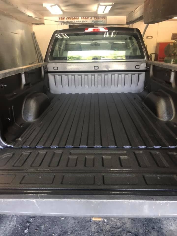 A black truck with a spray-on bed liner