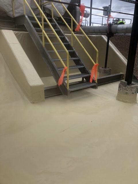 A set of stairs leading up to a building with a yellow railing.