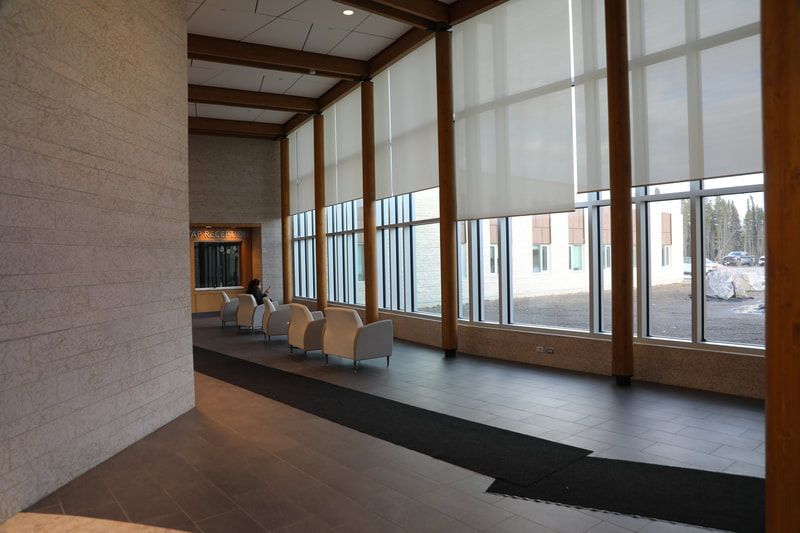 A large room with lots of windows and chairs
