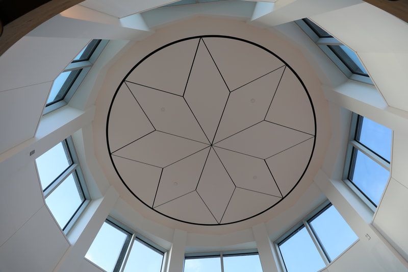 Looking up at the ceiling of a building with a circular design
