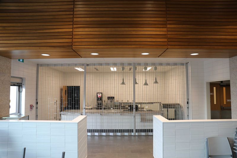 A restaurant with a sliding glass door that looks like a prison cell.